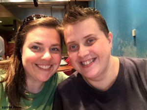 Lindsay and her wife, smiling, looking at camera