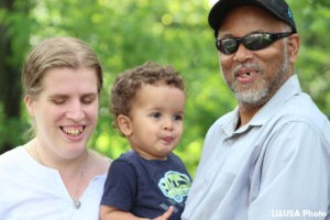 Kristen with her son, Langston and husband posing outdoors