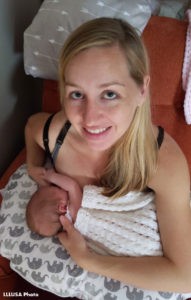 Holly nursing Lilliana with a nursing pillow