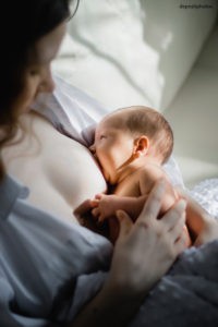 mother breastfeeding her newborn