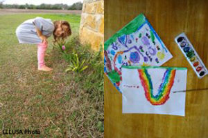 Child playing outdoors, painting supplies and art