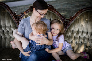 Family sitting on a couch, hugging