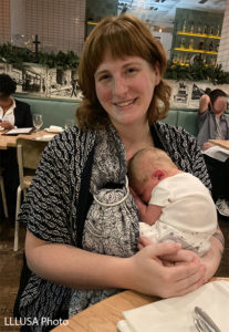 Rebecca with her newborn in a restaurant