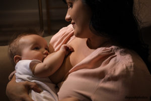 Woman breastfeeding her little baby night