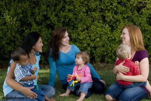 Group of mothers and thier children playing.