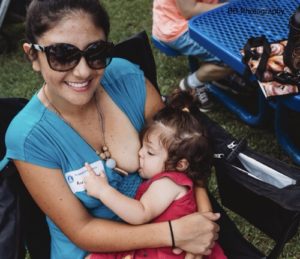 Mom breastfeeding her toddler at a LLL event