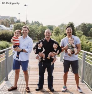 3 dads holding their babies, smiling