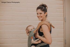 Mother breastfeeding her baby in a carrier
