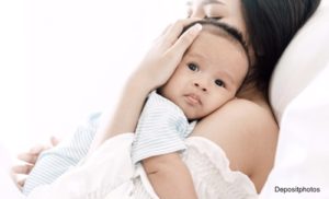 Mother holding her baby close