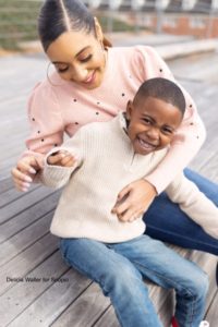 Mom and son outside, smiling