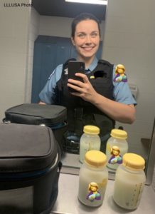Erin posing with 2 bottles of pumped milk
