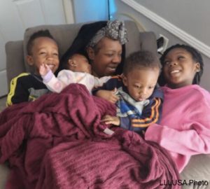 Shanice and her kids all together in the chair