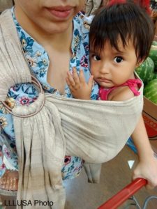 Child carried in a robozo While grocery shopping