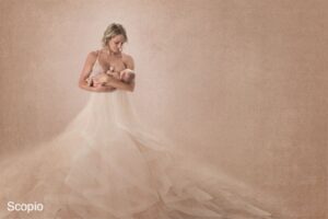 Mom nursing her baby in pink dress